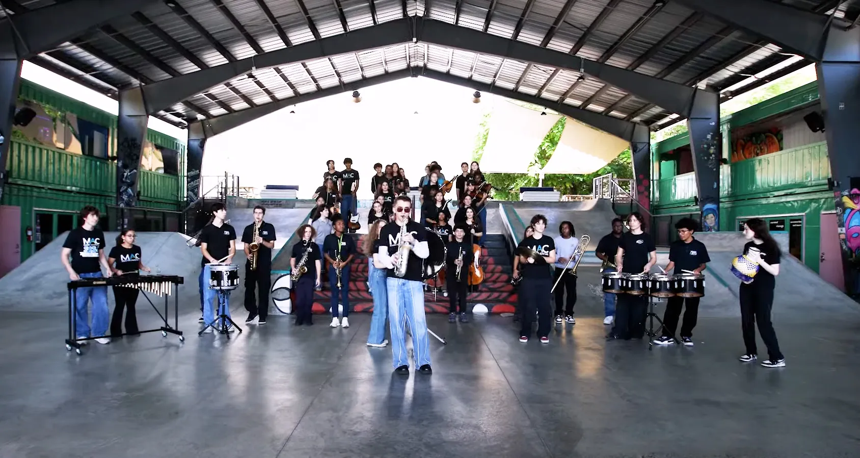 Students playing instruments inside of a skatepark venue