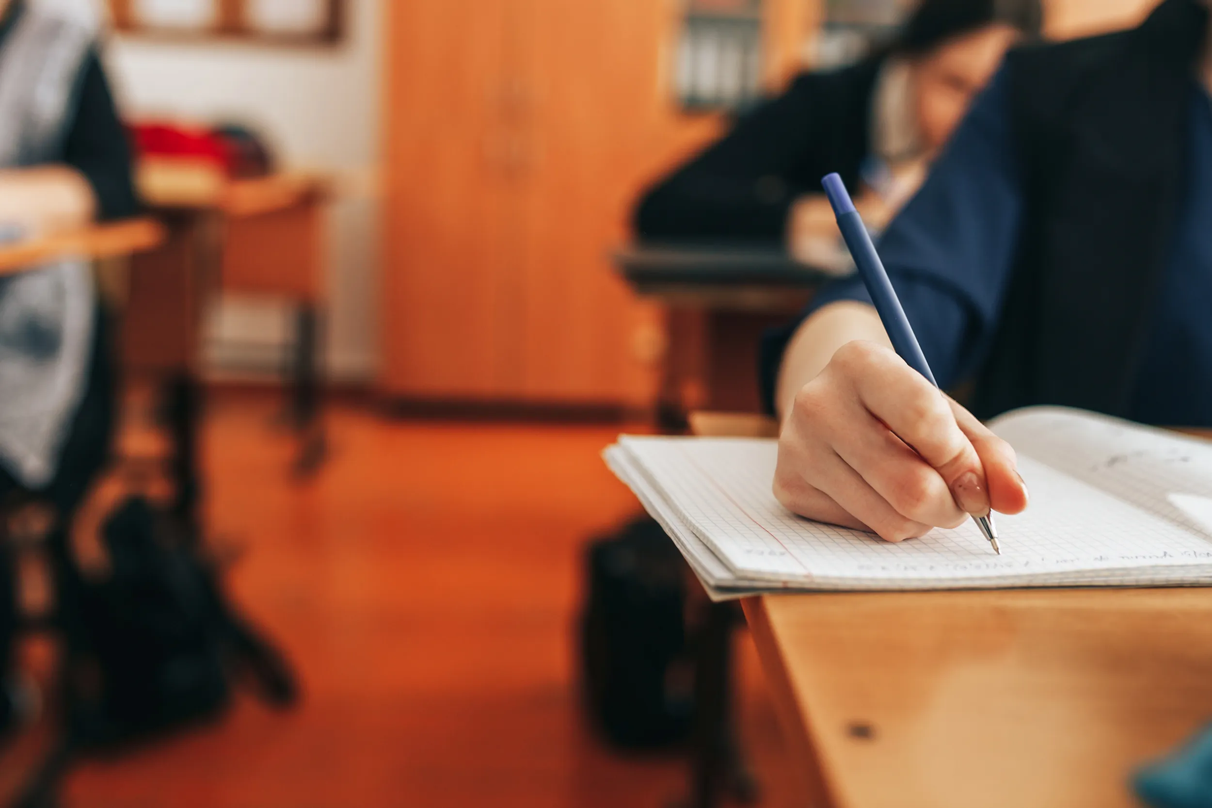 Student Writing in Class with a pen