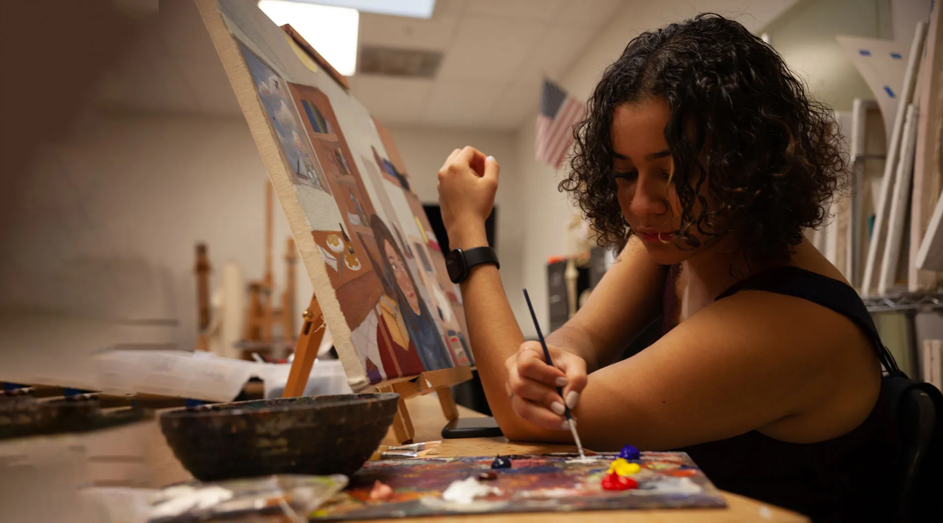 Student painting in class